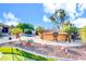 Outdoor bar overlooking a pool and grassy area, creating an inviting space for gatherings and outdoor fun at 42318 W Abbey Rd, Maricopa, AZ 85138