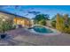 Private backyard oasis features a sparkling pool, lush landscaping, and relaxing patio area at 42318 W Abbey Rd, Maricopa, AZ 85138