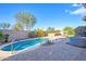 Inviting backyard featuring a pool, lush landscaping, and a spa for ultimate relaxation and enjoyment at 42318 W Abbey Rd, Maricopa, AZ 85138