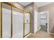 Shower with a gold framed glass door, tile flooring, and a view of a walk-in closet at 42318 W Abbey Rd, Maricopa, AZ 85138