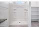 Shower with built-in shelves, next to a closet in this bright bathroom at 5106 E Midnight Star Dr, San Tan Valley, AZ 85143