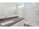 Clean white bathroom featuring a single sink vanity and shower with tiled surround at 5106 E Midnight Star Dr, San Tan Valley, AZ 85143