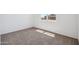 A sunny bedroom with neutral carpet and a view of another home through the window at 5106 E Midnight Star Dr, San Tan Valley, AZ 85143