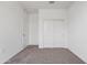 An airy bedroom with light brown carpet, closet with sliding doors, and a white door at 5106 E Midnight Star Dr, San Tan Valley, AZ 85143