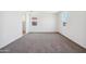 A spacious bedroom with plush carpeting and natural light from two windows at 5106 E Midnight Star Dr, San Tan Valley, AZ 85143