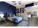Well-lit bedroom with a 'SURF' decoration above the bed, and light colored wooden accents at 5106 E Midnight Star Dr, San Tan Valley, AZ 85143