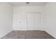 Bedroom with sliding door closet, interior door, and neutral carpet at 5106 E Midnight Star Dr, San Tan Valley, AZ 85143