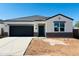 Charming single-story home with a dark gray roof, dark gray garage door, and xeriscaped front yard at 5106 E Midnight Star Dr, San Tan Valley, AZ 85143