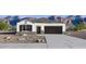 Charming single-story home with a well-maintained front yard and a two-car garage at 5106 E Midnight Star Dr, San Tan Valley, AZ 85143