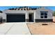 New construction home featuring a modern gray garage door and a bright white exterior at 5106 E Midnight Star Dr, San Tan Valley, AZ 85143