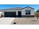 Charming single-story home featuring a black garage door and low-maintenance desert landscaping at 5106 E Midnight Star Dr, San Tan Valley, AZ 85143