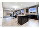 Bright, open-concept kitchen featuring granite countertops, an island, and seamless access to the living and dining areas at 5106 E Midnight Star Dr, San Tan Valley, AZ 85143
