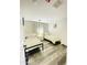 Cozy bedroom featuring two twin beds, wood-look floors, and white accents at 7136 N 73Rd Dr, Glendale, AZ 85303