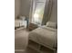 Cozy bedroom featuring two twin beds with modern white storage frames and a stylish nightstand at 7136 N 73Rd Dr, Glendale, AZ 85303