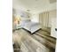 Primary bedroom featuring a queen bed, wood-look flooring, and neutral decor at 7136 N 73Rd Dr, Glendale, AZ 85303