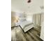 Cozy primary bedroom with a queen bed, bedside tables, and wood-look floors at 7136 N 73Rd Dr, Glendale, AZ 85303