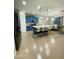 Modern kitchen with blue cabinetry, a white island with seating, and stainless steel appliances at 7136 N 73Rd Dr, Glendale, AZ 85303