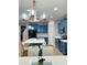 Modern kitchen with island, stainless appliances, quartz countertops and luxury lighting at 7136 N 73Rd Dr, Glendale, AZ 85303