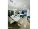 Kitchen and dining room area, featuring blue cabinets, modern island, stainless appliances at 7136 N 73Rd Dr, Glendale, AZ 85303