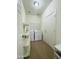 Laundry room with washer, dryer, storage shelves and access door at 7136 N 73Rd Dr, Glendale, AZ 85303