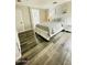 Bedroom showcasing a queen bed, a view to the ensuite, and wood-look flooring at 7136 N 73Rd Dr, Glendale, AZ 85303