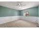 Cozy bedroom featuring neutral carpet, green walls, and a window view to the community at 8020 E Keats Ave # 285, Mesa, AZ 85209