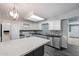 Well-lit kitchen with white cabinets, stainless steel appliances, and a central island with stylish pendant lighting at 8020 E Keats Ave # 285, Mesa, AZ 85209