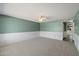 Spacious living room with green walls, white trim, and a ceiling fan at 8020 E Keats Ave # 285, Mesa, AZ 85209