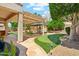 Beautiful backyard with a putting green, pergola covered patio, and gazebo providing great outdoor living at 8046 W Yukon Dr, Peoria, AZ 85382
