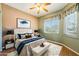 Relaxing bedroom with ceiling fan, soft carpet, and plenty of natural light at 8046 W Yukon Dr, Peoria, AZ 85382