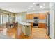 Bright kitchen with an island, wood cabinets, stainless steel appliances, and dining area at 8046 W Yukon Dr, Peoria, AZ 85382