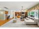 Open-concept living room with fireplace, built-in shelves, and adjacent desk area at 8046 W Yukon Dr, Peoria, AZ 85382