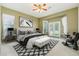 Comfortable main bedroom with a decorative rug, bench, and French doors to the outside at 8046 W Yukon Dr, Peoria, AZ 85382