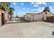 Home exterior with a fenced-in pool area, mature trees, and a large concrete driveway at 946 S Pomeroy Cir, Mesa, AZ 85210