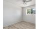 Bedroom with new vinyl floors, ceiling fan, and a bright window at 946 S Pomeroy Cir, Mesa, AZ 85210