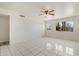 Bright living room features tile flooring and natural light streaming through a window with backyard view at 946 S Pomeroy Cir, Mesa, AZ 85210