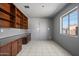 Spacious office with a built-in desk, shelving, and a sunlit window at 946 S Pomeroy Cir, Mesa, AZ 85210