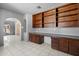 Bright room with built in wooden desk and shelving, and tile flooring at 946 S Pomeroy Cir, Mesa, AZ 85210