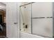 Bathroom featuring a shower-tub combo with sliding glass doors for easy access at 10030 W Indian School Rd # 221, Phoenix, AZ 85037