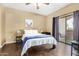 Bright bedroom with sliding glass door to balcony and stylish modern décor at 10030 W Indian School Rd # 221, Phoenix, AZ 85037