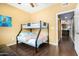 Bedroom featuring bunkbeds and a door leading to the bathroom and kitchen at 10030 W Indian School Rd # 221, Phoenix, AZ 85037