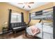 Bedroom featuring bunkbeds, a couch and a window with natural light at 10030 W Indian School Rd # 221, Phoenix, AZ 85037