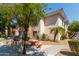 Inviting condo featuring outdoor grilling and seating area surrounded by mature landscaping at 10030 W Indian School Rd # 221, Phoenix, AZ 85037