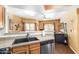 Well-equipped kitchen with stainless steel appliances that opens up to the cozy living area at 10030 W Indian School Rd # 221, Phoenix, AZ 85037
