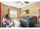 Comfortable living room featuring sleek black furniture and a large window for natural light at 10030 W Indian School Rd # 221, Phoenix, AZ 85037