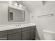 Bright bathroom features gray cabinets, white countertops, and chrome fixtures at 1056 N Miller Rd, Tempe, AZ 85288