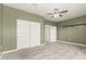 Bedroom features neutral carpeting, a large closet with sliding doors, and two separate doors to adjacent rooms at 1056 N Miller Rd, Tempe, AZ 85288