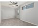 Bedroom features neutral carpeting, two windows, recessed lighting, and a ceiling fan at 1056 N Miller Rd, Tempe, AZ 85288