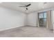 Large bonus room with neutral carpeting, recessed lighting, ceiling fan, and sliding doors to the outside at 1056 N Miller Rd, Tempe, AZ 85288