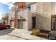 Two-story townhome showcasing private garages, balconies, modern facade, and desert landscaping at 1056 N Miller Rd, Tempe, AZ 85288